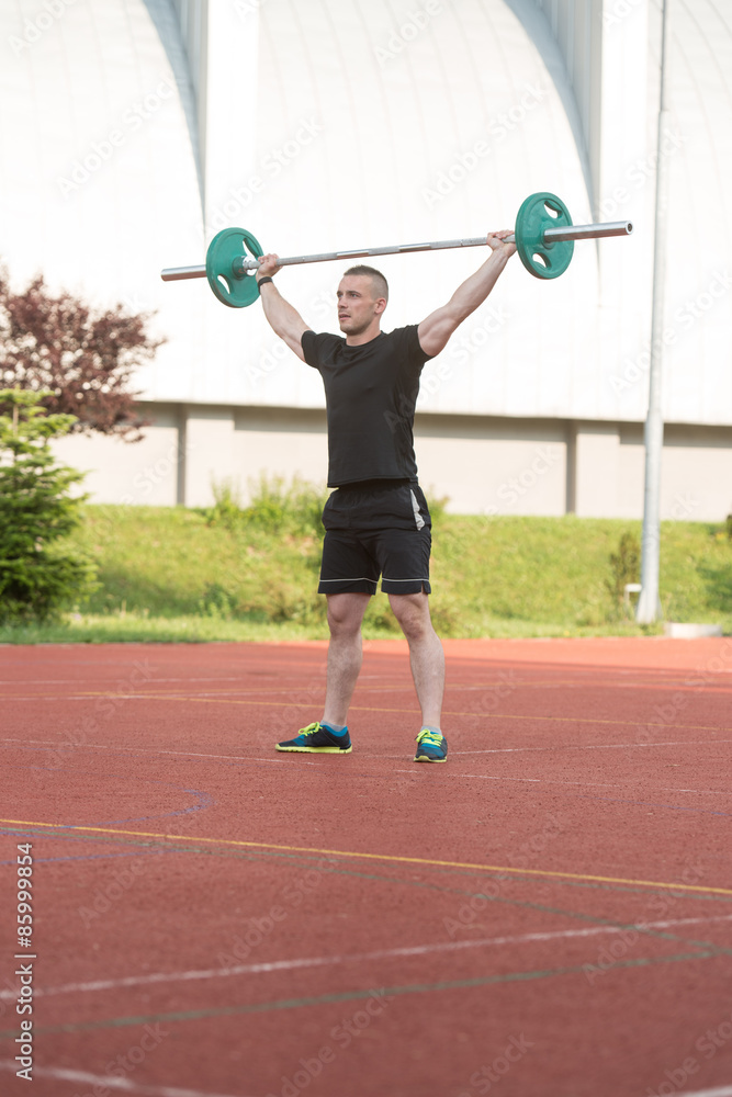 Young Man Doing A Overhead Squat Exercise Outdoor