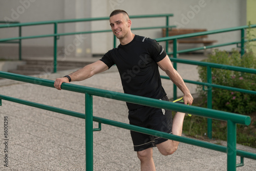 Young Man Is Streching Outdoors