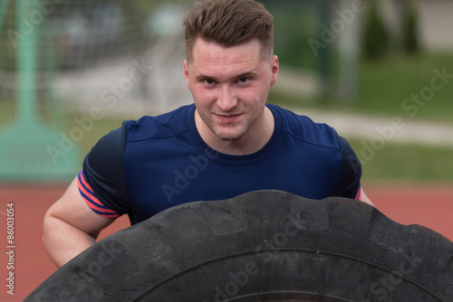 Young Man Doing Tire Workout Outdoor