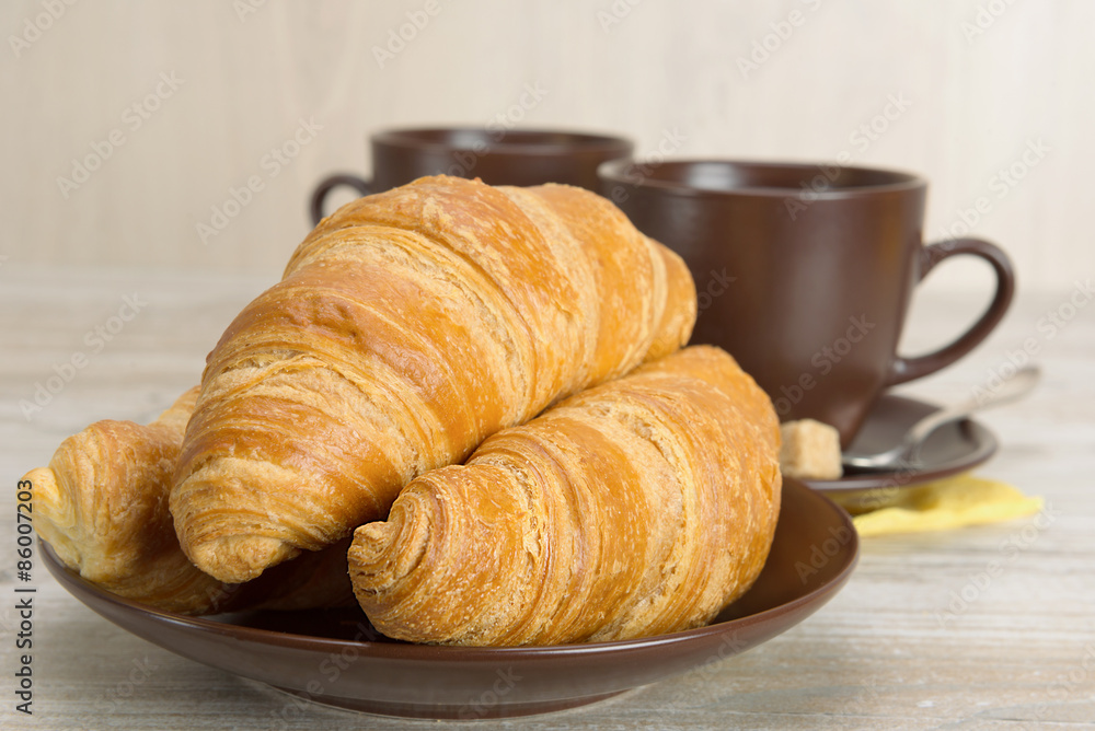 croissants and coffee in cups croissants and coffee in cups