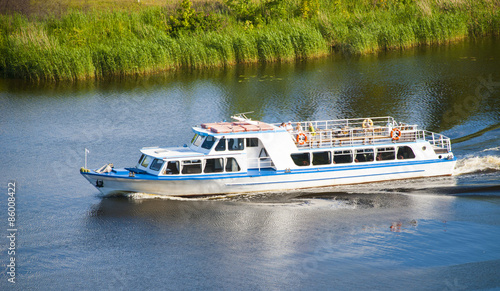 Fotografie Passenger  boat in tourist business  floating on river