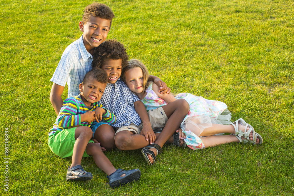 Four children are playing on the glade. Four children are playing on the glade.