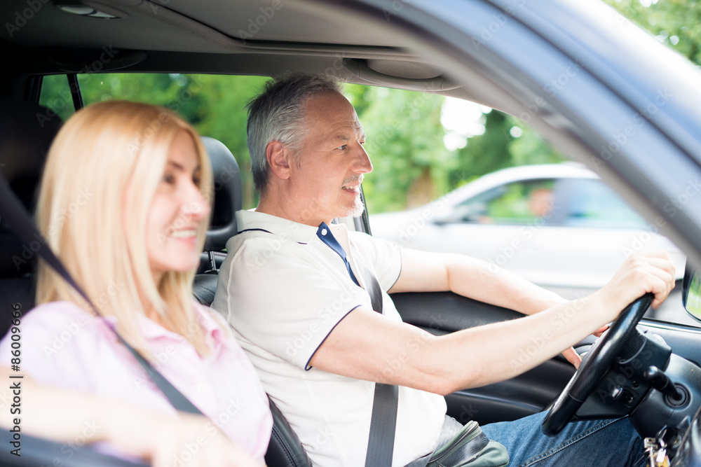 Mature couple traveling in their car Mature couple traveling in their car