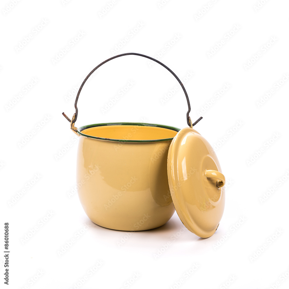 The yellow metal pot with a lid. The yellow metal pot with a lid.