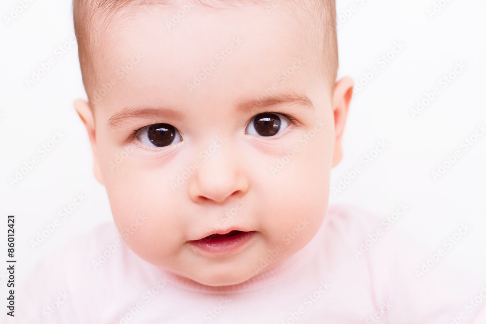 Close-up portrait of a beautiful baby on white background