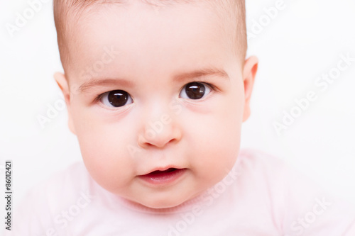 Close-up portrait of a beautiful baby on white background
