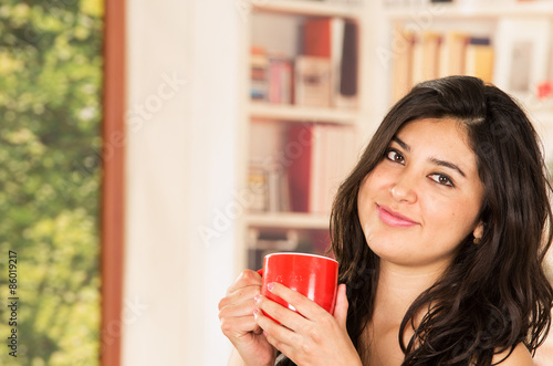 Hispanic model with coffee cup