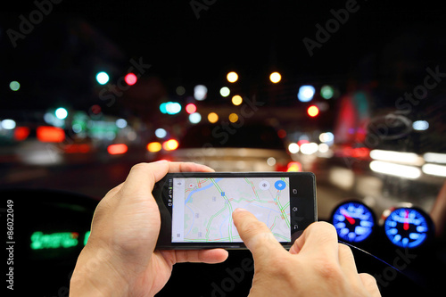 die-cut map on smart phone and blur of traffic view in background photo