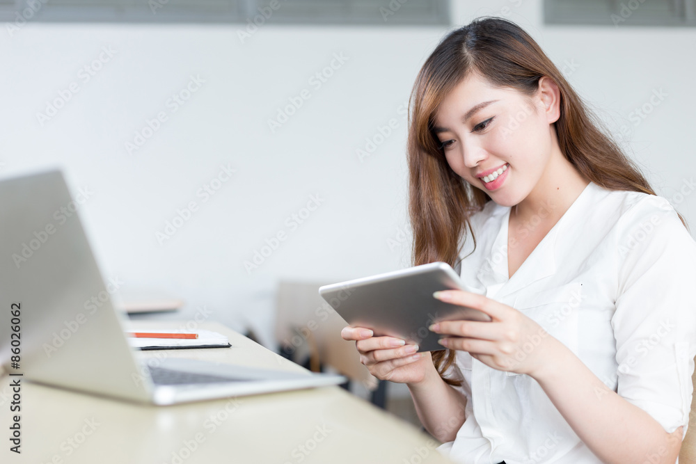 Asian beautiful female student study with tablet in classroom Asian beautiful female student study with tablet in classroom