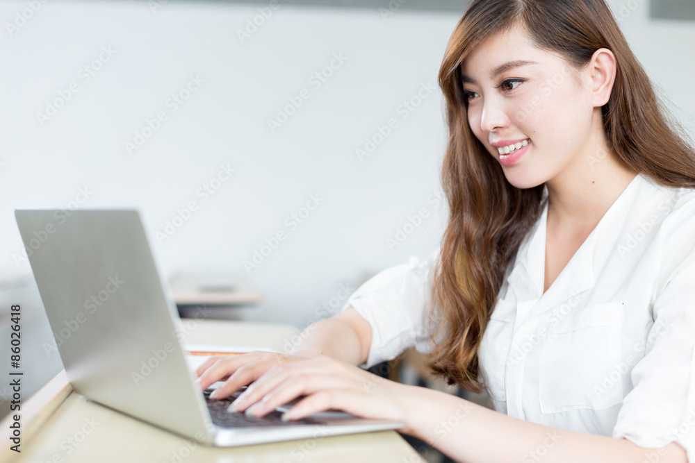 Asian beautiful female student study with laptop in classroom Asian beautiful female student study with laptop in classroom