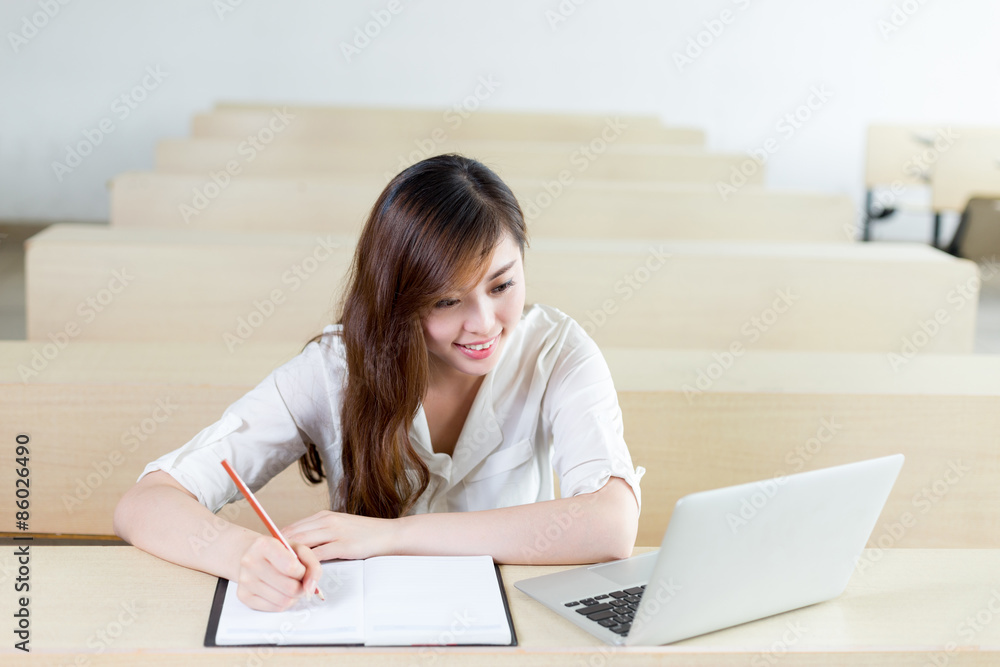 Asian beautiful female student study with laptop in classroom Asian beautiful female student study with laptop in classroom