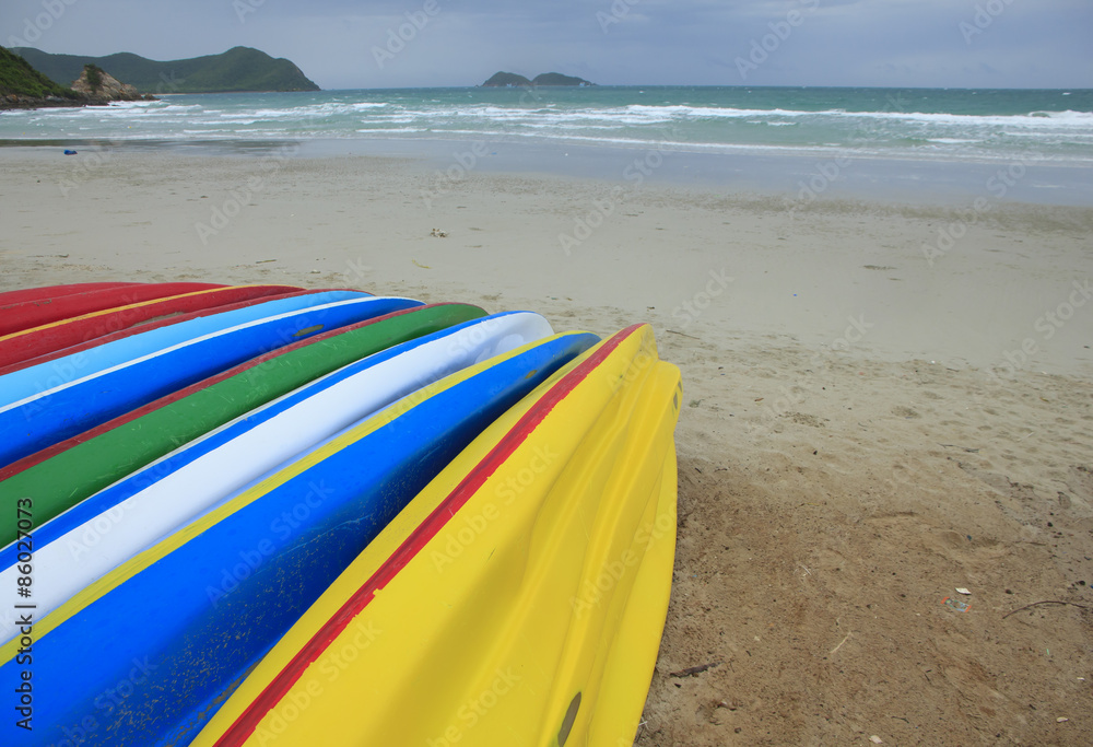 Stock Photo - Row of Kayaks beside the sea Stock Photo - Row of Kayaks beside the sea