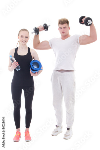 young man and woman in sportswear with dumbbells and yoga mat is