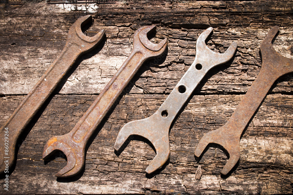 iron rusty tools wrench on an old wooden table iron rusty tools wrench on an old wooden table