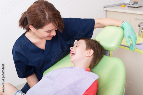 Relax kid laughing in dentist chair