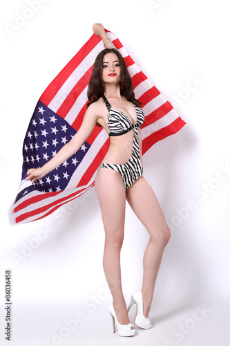 Sexy young woman posing over american flag background