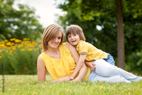 Young beautiful mom and her cute little boy, relaxing and having © Tomsickova