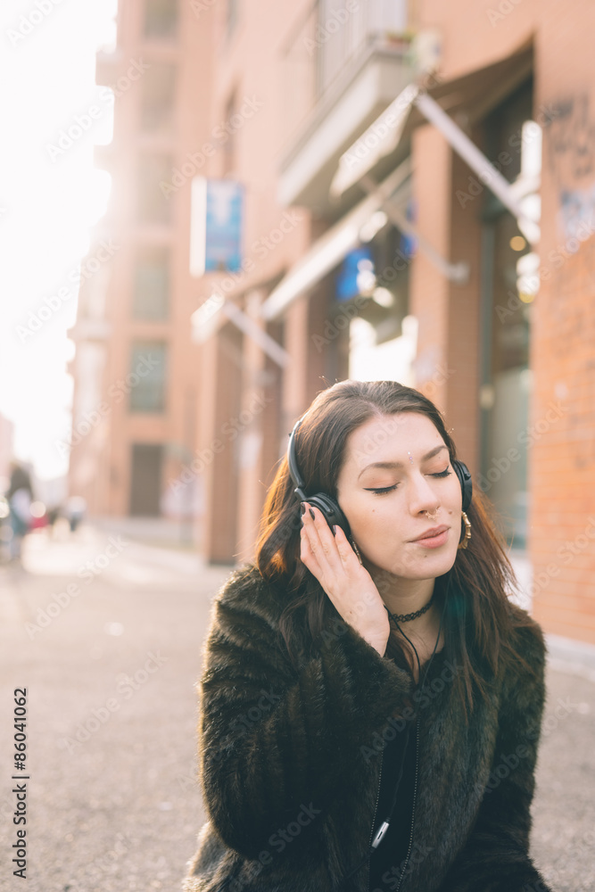 Fototapeta premium young beautiful woman listening to music with headphones