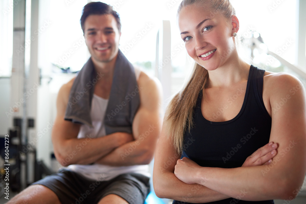 Fit Couple Smiling at Camera with Arms Crossed Fit Couple Smiling at Camera with Arms Crossed