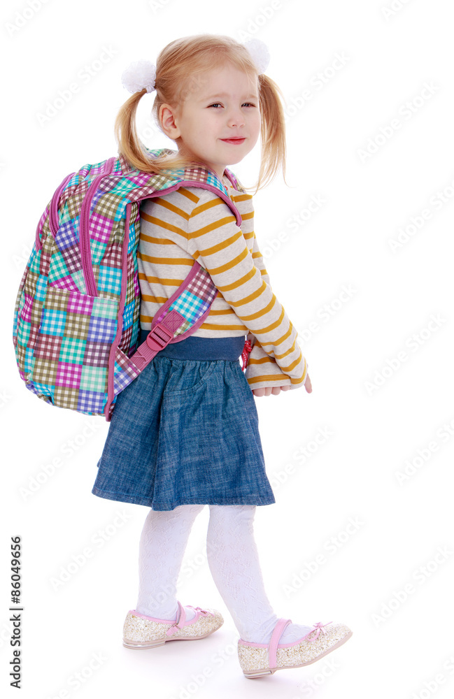 Adorable little girl in pigtails with a big knapsack on his back Adorable little girl in pigtails with a big knapsack on his back