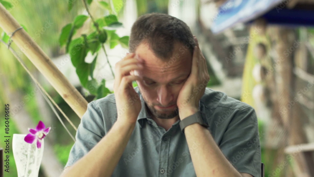 Sad, unhappy man eating meal in exotic cafe
Sad, unhappy man eating meal in exotic cafe
