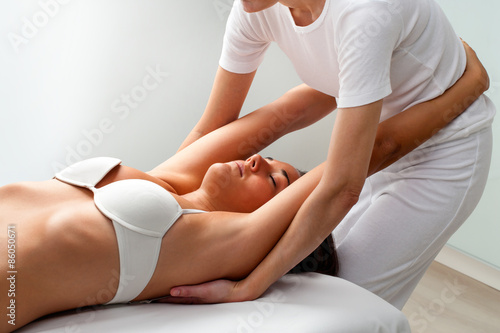 Woman receiving osteopathic treatment.