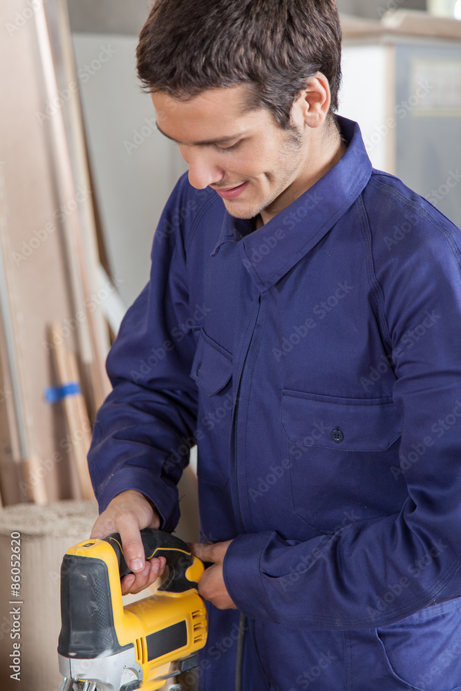 Carpenter using a electric saw Carpenter using a electric saw