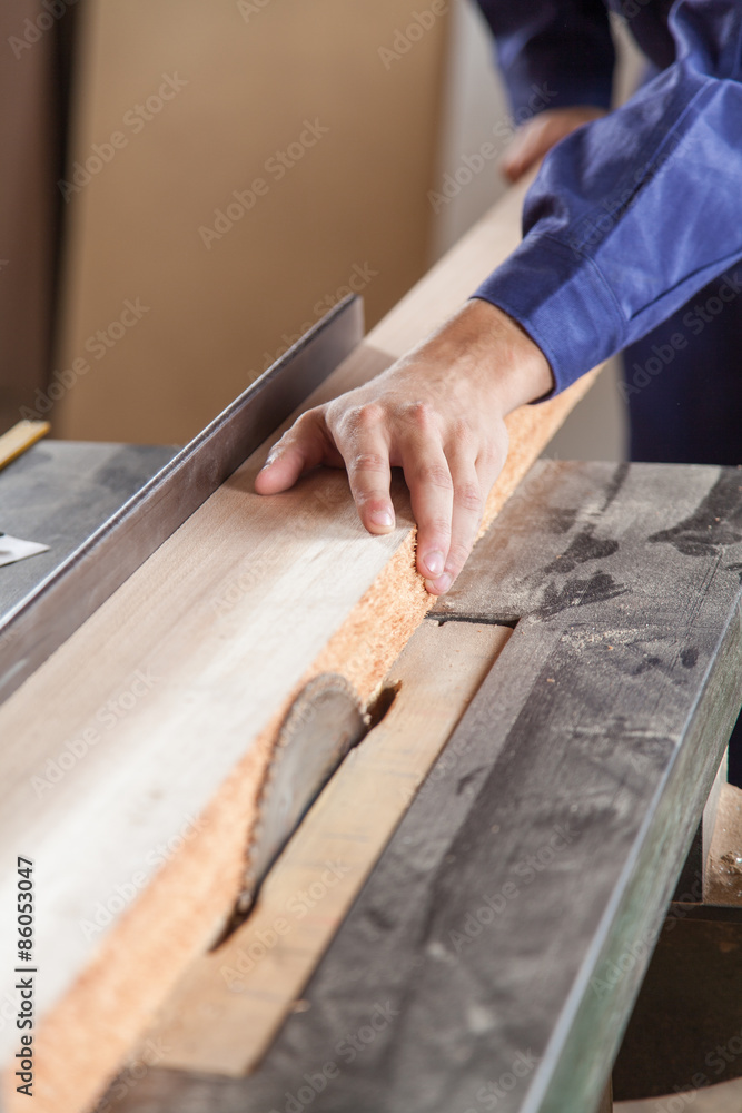 Carpenter cutting a plank Carpenter cutting a plank