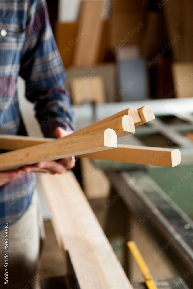 Carpenter holding a pieces of wood Carpenter holding a pieces of wood