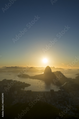 Scenic Rio de Janeiro Brazil golden sunrise over Guanabara Bay with a skyline silhouette of Sugarloaf Mountain