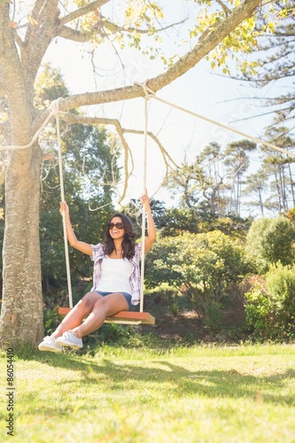 Pretty brunette swinging in park  © WavebreakmediaMicro