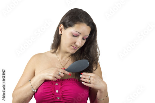 Beautiful girl combing her hair