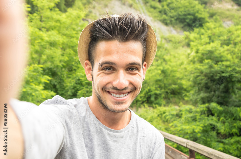 Guy takes a selfie with his smartphone during his holiday - lifestyle anche technology concept Guy takes a selfie with his smartphone during his holiday - lifestyle anche technology concept