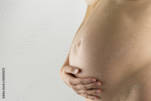 Wallpaper Mural Closeup of pregnant woman holding her bare swollen belly Torontodigital.ca