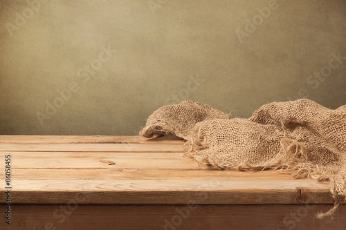 Vintage background with wooden table and sackcloth photo