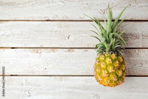 Summer background with pineapple on wooden board