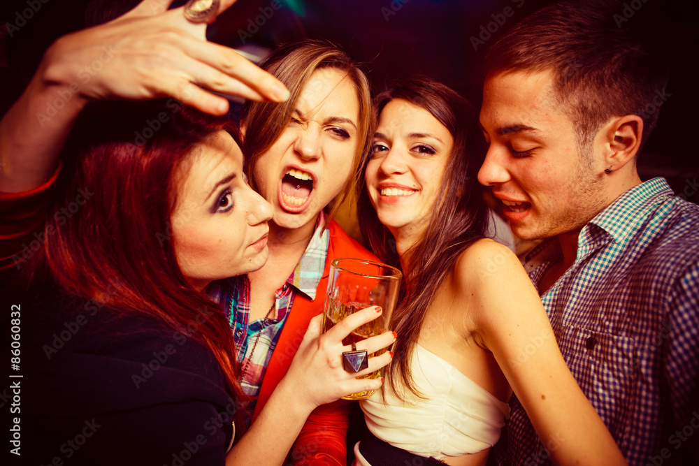 People in night club. Dancing, drinking and having fun