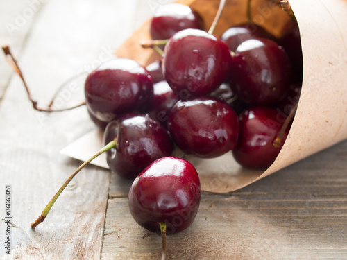 Fresh cherries on a wooden table in a kitchen