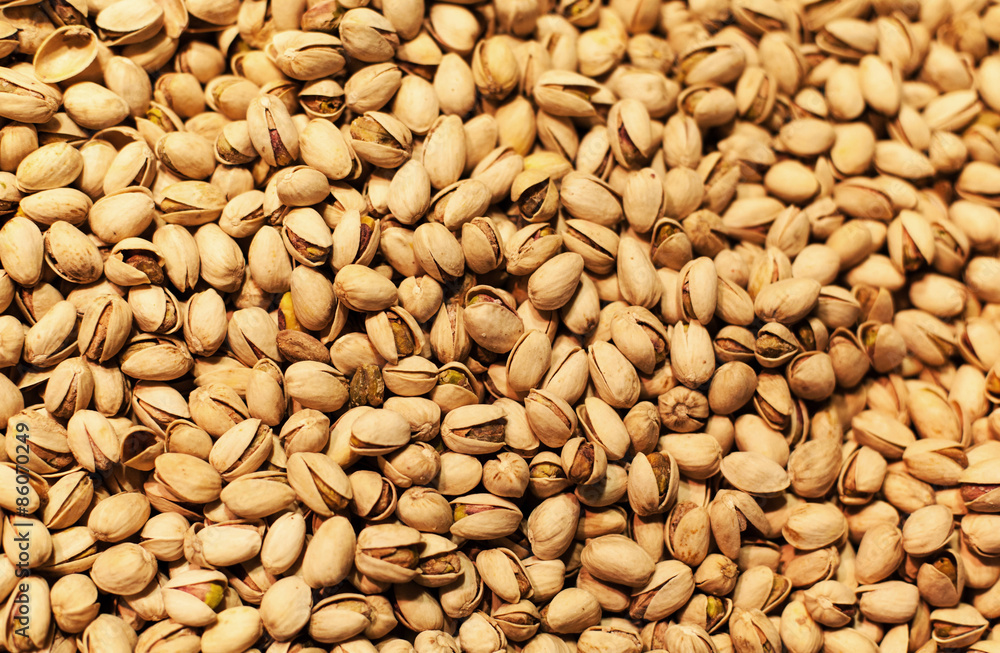 Pistachios background on a market stall close-up. Food healthy b Pistachios background on a market stall close-up. Food healthy b
