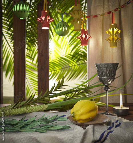 Symbols of the Jewish holiday Sukkot with palm leaves and candle