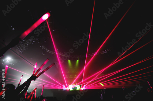 EDM. concert, silhouettes of happy people raising up hands