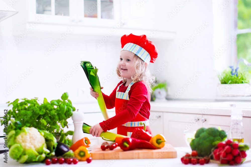 Little girl in chef hat preparing lunch Little girl in chef hat preparing lunch