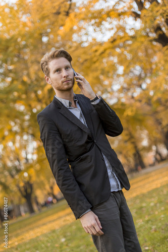 Young man with mobile phone...