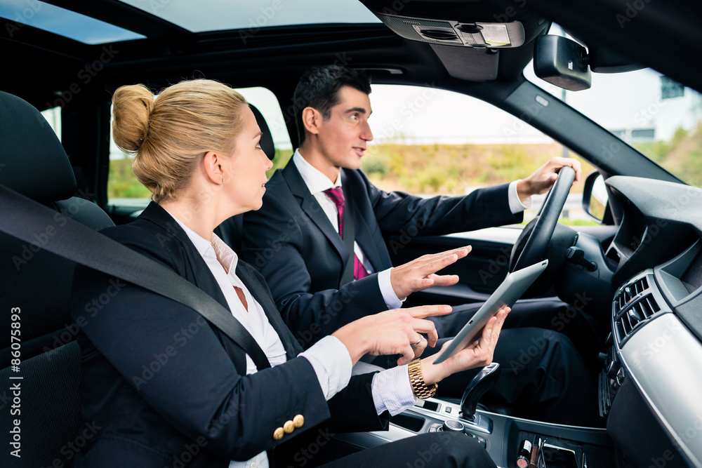 Couple in car being lost navigating with map Couple in car being lost navigating with map