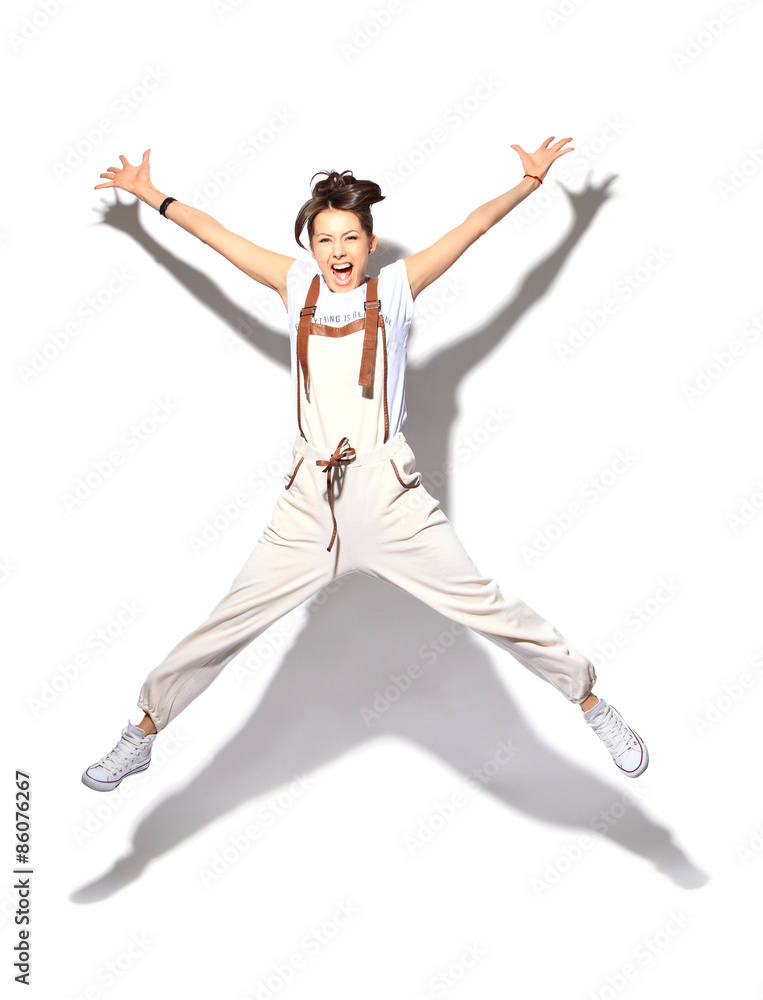 Fototapeta premium Young casual woman, student jumping. Isolated on white