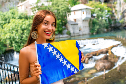 Woman with Bosnian flag in Blagaj village