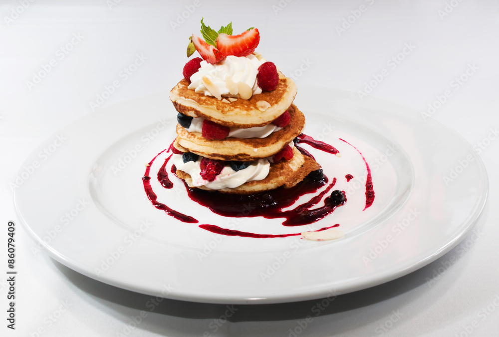 Crumpets with raspberry sauce , whipped curd cheese and roasted almonds