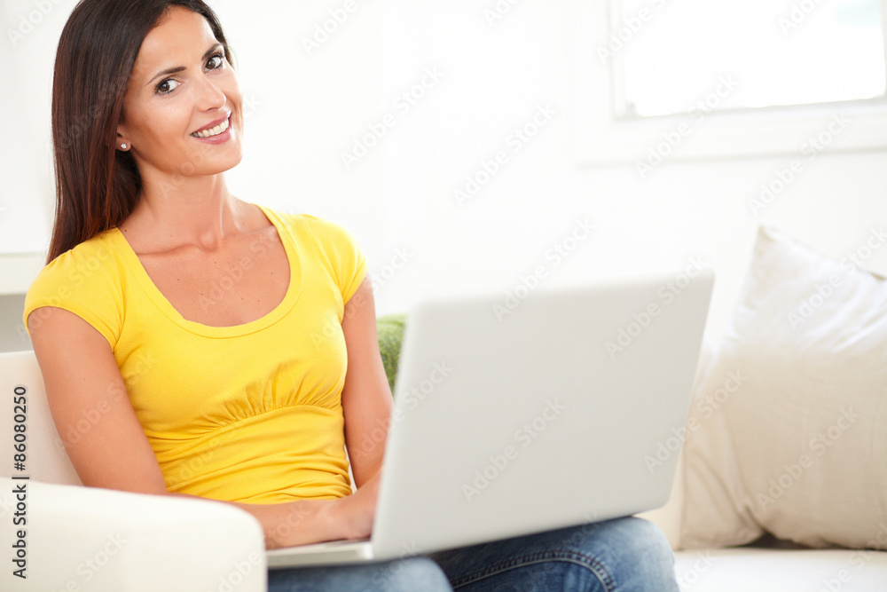 Smiling student using a laptop indoors Smiling student using a laptop indoors