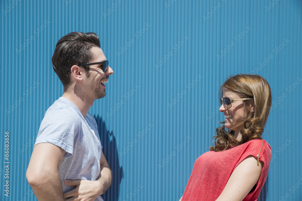 Friends or couple laughing and taking a conversation Friends or couple laughing and taking a conversation