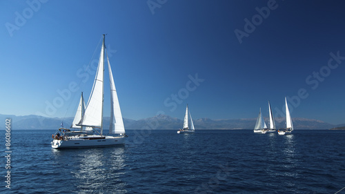 Ship yachts with white sails in the open Sea. Boats in sailing regatta. Sailing yacht race. © De Visu